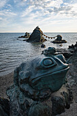  View of Meoto Iwa with frog sculptures in the foreground, Okitama Shrine, Futamichōe, Futamichoe, Ise, Japan; Asia 