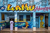  Man and dogs in front of Lamu Adventures shop and tour office, Lamu, Lamu Island, Kenya, Africa 