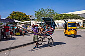  Human powered rickshaw with family inside, Mahajanga, Boeny, Madagascar, Indian Ocean 