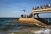  Pier on the beach with people jumping into the sea, Mahajanga, Boeny, Madagascar, Indian Ocean 