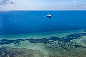  Aerial view of expedition cruise ship SH Diana (Swan Hellenic) near reef, Astove Island, Cosmoledo Group, Outer Seychelles, Seychelles, Indian Ocean 