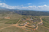  Aerial view of four-wheel drive vehicles on a dirt road near village on Diksam Plateau, Gallaba, Socotra Island, Yemen, Middle East 