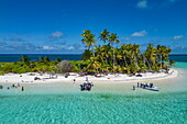  Aerial view of a motorized Zodiac inflatable boat from the expedition cruise ship SH Diana (Swan Hellenic) and people on the beach with coconut trees, Bijoutier Island, Alphonse Group, Outer Seychelles, Seychelles, Indian Ocean 