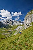  Man and woman hiking with a view of Tschingelhörner and Lower Segnesboden, Tectonic Arena Sardona, Glarus Main Thrust, UNESCO World Natural Heritage Glarus Alps, Glarus Alps, Graubünden, Switzerland  
