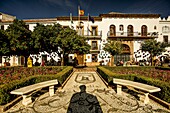  Plaza de los Naranjos in the old town of Marbella with view to the town hall, silhouette of the bust of King Juan Carlos in the foreground, Costa del Sol, Andalusia, Spain 