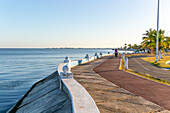 People exercising on pathway by the coast on the seafront Malecon, Campeche city, Campeche State, Mexico
