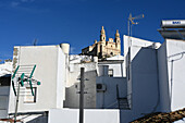 Weiße Mauern und Blick zur Iglesia Mayor de Olvera an der Straße der weißen Dörfer 'Pueblos Blancos', Olvera, Provinz Cádiz, Andalusien, Spanien