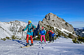  Four people on ski tour ascending to Auerspitze, Ruchenköpfe in the background, Spitzing area, Bavarian Alps, Upper Bavaria, Bavaria, Germany  
