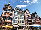  Half-timbered houses and restaurants at Römerberg against a blue sky, Frankfurt/Main, Hesse, Germany 