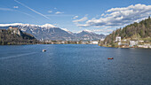  View over Lake Bled to the castle and the snowy mountains behind in Bled, Slovenia, Europe. 