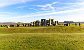 Tourists view standing stones of Neolithic henge, Stonehenge, Wiltshire, England, UK