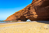 Natural rock coastal arch erosional landform on beach, Legzira, southern Morocco, north Africa