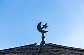 Cresecent moon and star symbol on roof against blue sky, Taroudant, Sous Valley, Morocco, north Africa