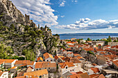  The old town of Omis with the ruins of the fortress Mirabella or Peovica seen from above, Croatia, Europe  