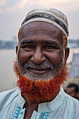  Portrait of a smiling Muslim man with an orange beard symbolizing that he has visited Mecca, Barisal (Barishal), Barisal District, Bangladesh, Asia 