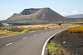 Road leading to cone of Mount Corona volcano and Ye village, Haria, Lanzarote, Canary Islands, Spain