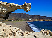 Beach and sculpted rock structure, Los Escullos, Cabo de Gata natural park, Almeria, Spain
