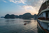  Aerial view of cruise ship Ylang (Heritage Line) with sea kayak at sunset, Lan Ha Bay, Haiphong, Vietnam, Asia 