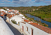 Landscape view of valley of river Rio Guadiana over rooftops in the medieval village of Mértola, Baixo Alentejo, Portugal, Southern Europe