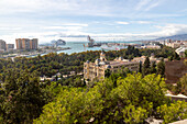 Cityscape view over city centre and dock area Malaga, Andalusia, Spain - Trasmediterranea ferry in port, city hall Ayuntamiento in centre