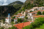 View over houses and rooftops to Greek Orthodox Church of Saint Spyridon, village of Dhermi, Albania