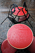   Bistrot tables red in the rain, Paris 