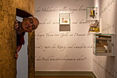  Man looking through exhibition in the Brothers Grimm House Museum, Steinau an der Straße, Spessart-Mainland, Hesse, Germany 