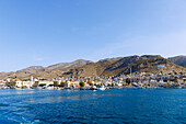  Island capital Póthia with customs and port office, nautical museum, town hall (Dimarchio) and pastel-colored houses and boats in the harbor on the island of Kalymnos (Kalimnos) in Greece 