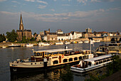 Evening light boats buildings, River Maas or Meuse, Maastricht, Limburg province, Netherlands,