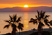  Sunset behind the Turkish coast at Tigaki (Tingaki) beach on the island of Kos in Greece 