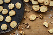  Sablés with walnuts, on tray / grid and wooden board 