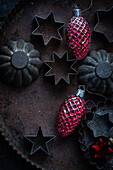  Old cookie cutters on tin with old Christmas tree decorations 