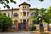 Contemporary sculpture in front of  an old building housing the Institute for Studies on the Crimes and Consequences of Communism (Iskk Albania), Tirana, Albania, Southeastern Europe