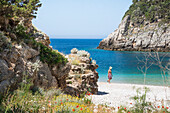 Woman walking on the Beach of Dafines bay, Peninsula of Karaburun, within the Karaburun-Sazan Marine Parc, Vlore bay, Albania, Southeastern Europe