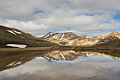  Colourful rhyolite mountains with snow remnants at Brennisteinsalda volcano in Landmannalaugar, Fjallabak National Park, Sudurland, Iceland 