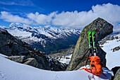  Skis and backpack leaning against rock tower, Southern Windbachspitz, Zillertal Alps, Tyrol, Austria 