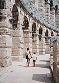  Two tourists inside the Roman Amphitheatre in Pula, Istria, Croatia. 