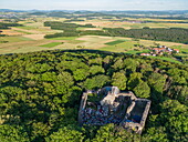  Aerial view of the Hauneck castle ruins with a view of the village of Unterstoppel and fields in the distance, Haunetal Oberstoppel, Hessisches Kegelspiel, Rhön, Hesse, Germany, Europe 