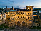  Aerial view of the ancient Roman city gate Porta Nigra and the city at dusk, Trier, Rhineland-Palatinate, Germany, Europe 