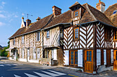  Main street with half-timbered houses in Beuvron-en-Auge in the Pays d&#39;Auge in the Calvados department in the Normandy region of France 