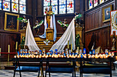  lit offering candles and prayer candles with statue of the Holy Mother of God in the interior of the church of Sainte-Catherine in Honfleur on the Flower Coast (Côte Fleurie, Cote Fleurie) in the Calvados department in the Normandy region of France 