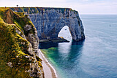  Chalk cliffs with rock gate La Manneporte in Etretat (Étretat) at high tide on the Alabaster Coast (Côte d&#39;Albâtre, Cote d&#39;Albatre) in the Seine-Maritime department in the Normandy region of France 