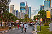 People walk in the Huacheng Square surrounded by modern high-rise buildings. Zhujiang New Town, Tianhe District, Guangzhou, Guangdong Province, China.