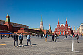 People walk in the Red Square on a clear sunny day. Moscow, Russian Federation.