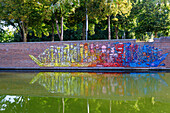  Street art &quot;La barque / The bark&quot; by Bault on the canal wall at Parc Saint-Pierre, created during the ICONIC 2021 festival in the Saint-Leu district of Amiens in the Somme department in the Hauts-de-France region of France 