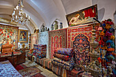 Colorful selection of handmade Persian carpets in a shop in the Aminoddole Caravanserai, historic structure in the Grand Bazaar of Kashan, Iran.