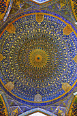 View from below of domed ceiling of the main prayer hall in the Shah Mosque (Masjed-e Shah) with its elaborate tiling. Isfahan, Iran.