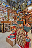 Handmade copper vases inlaid with Persian turquoise displayed in a handicraft shop in Isfahan, Iran.