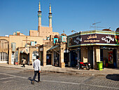 A man crosses the street in the historic town of Yazd, Iran.