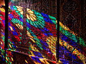 A play of light from multi-colored stained-glass windows inside the 19th century Nasir al-Mulk Mosque, aka the Pink Mosque. Shiraz, Iran.